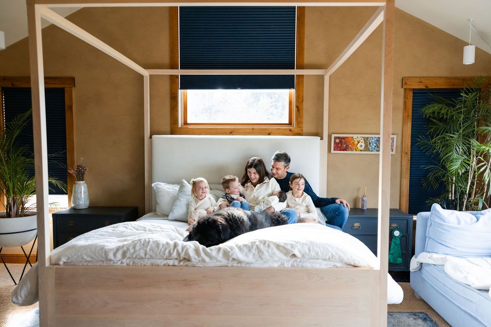 salt lake city utah family photographer, candid photo of a big family having a messy snuggle with a newborn on the bed