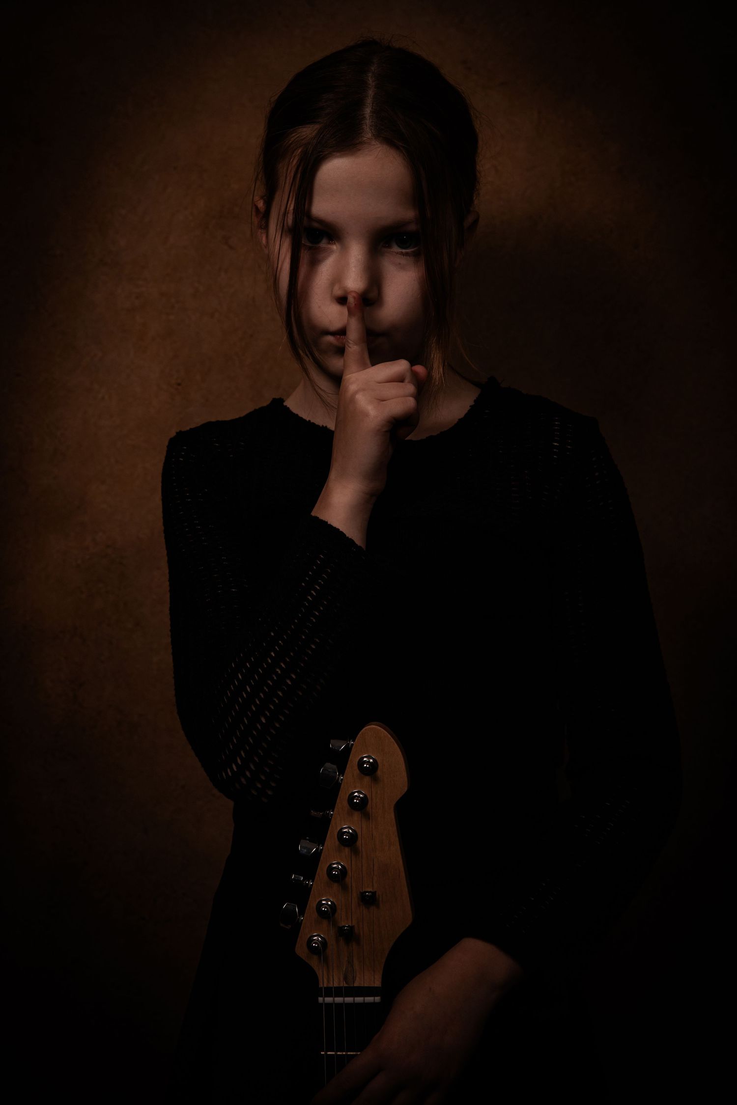 Moody portrait series with bass guitar in dark atmospheric lighting.