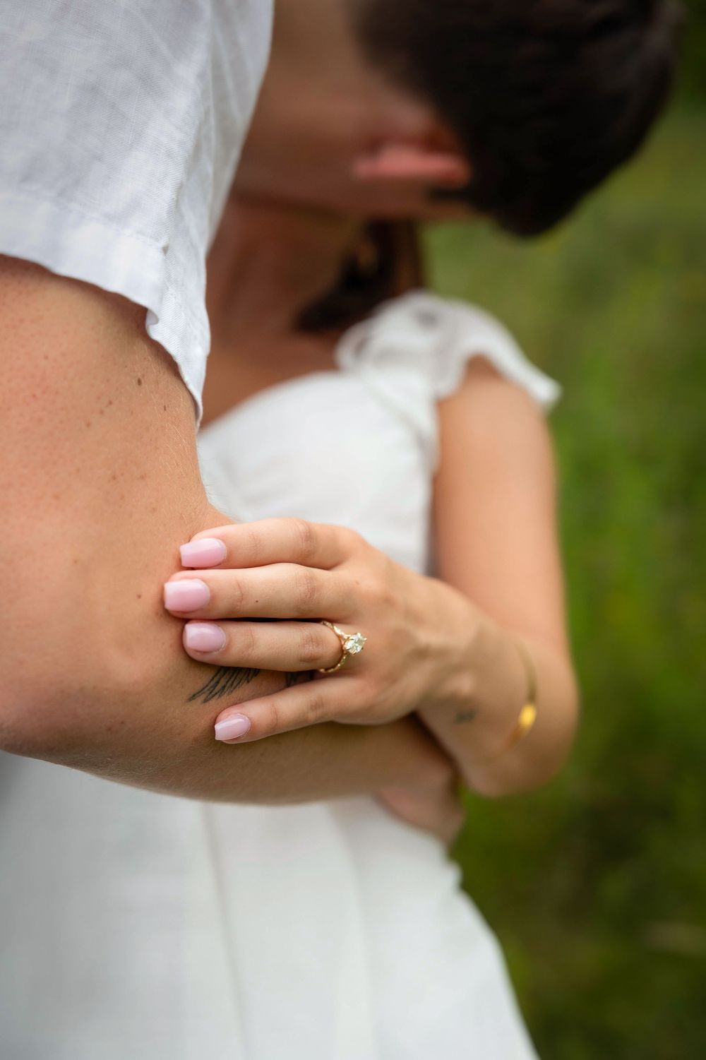 diamond ring in focus kiss in background
