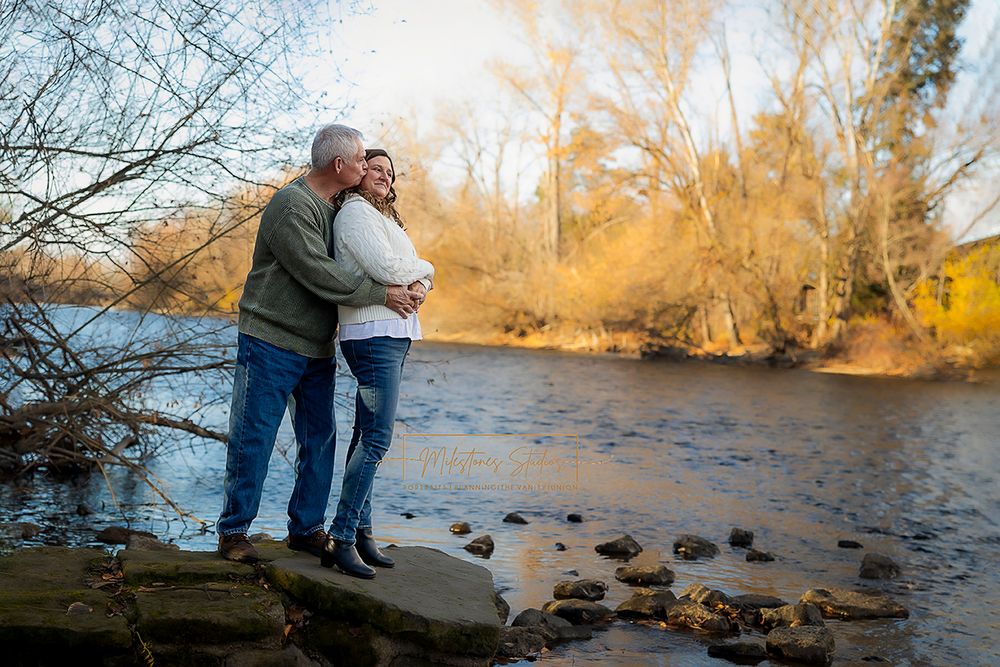 Engaged older couple standing together near river