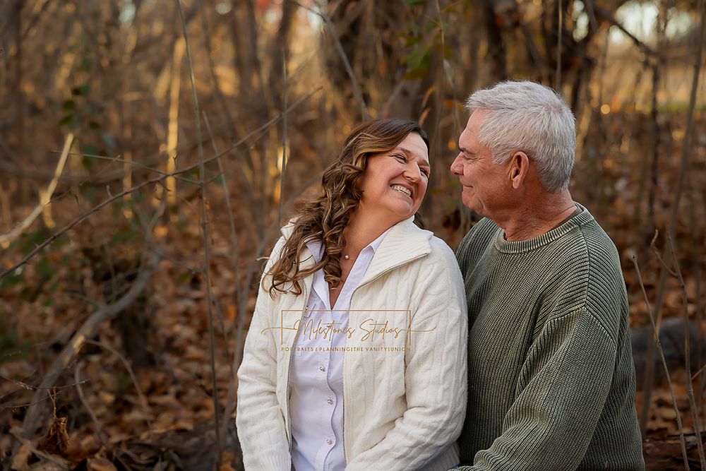 Engaged older couple fall foliage looking at each other