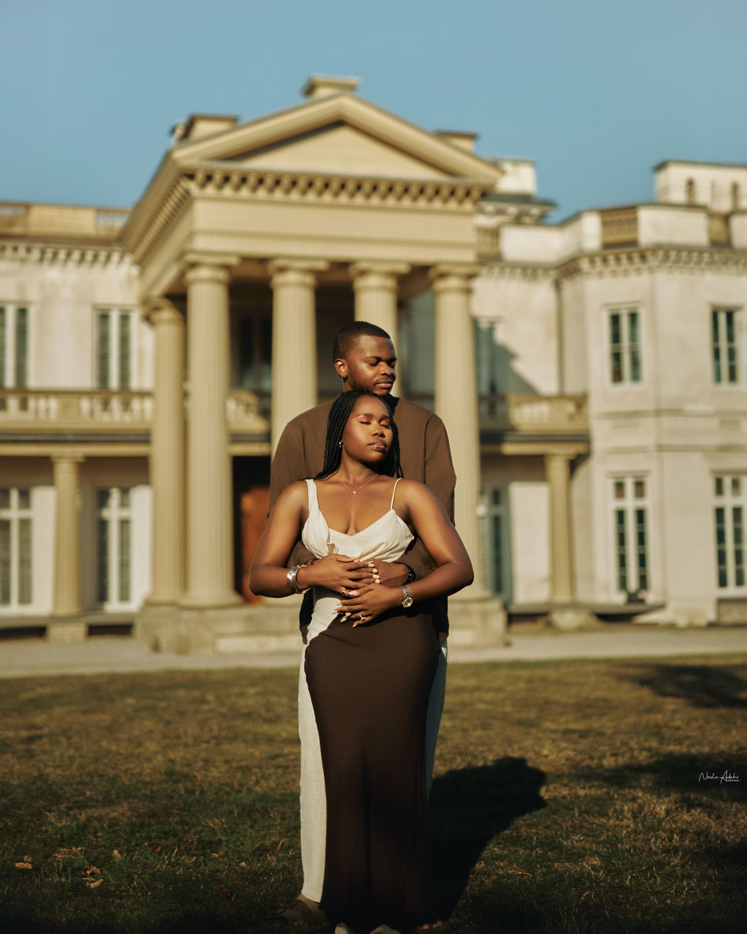 Bride and groom dancing during luxury Nigerian reception with floral installations