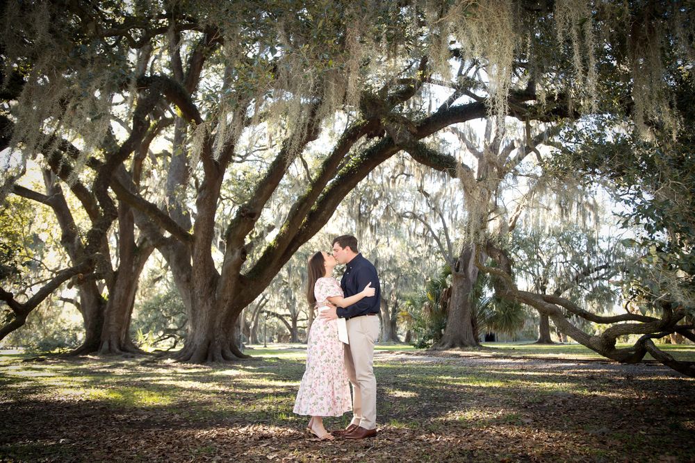 Scenic engagement photos under Spanish moss-draped oak trees in a park setting.