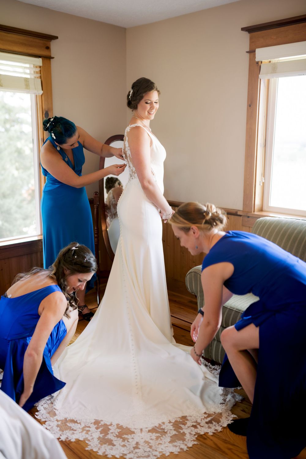 Bridesmaids helping bride get ready