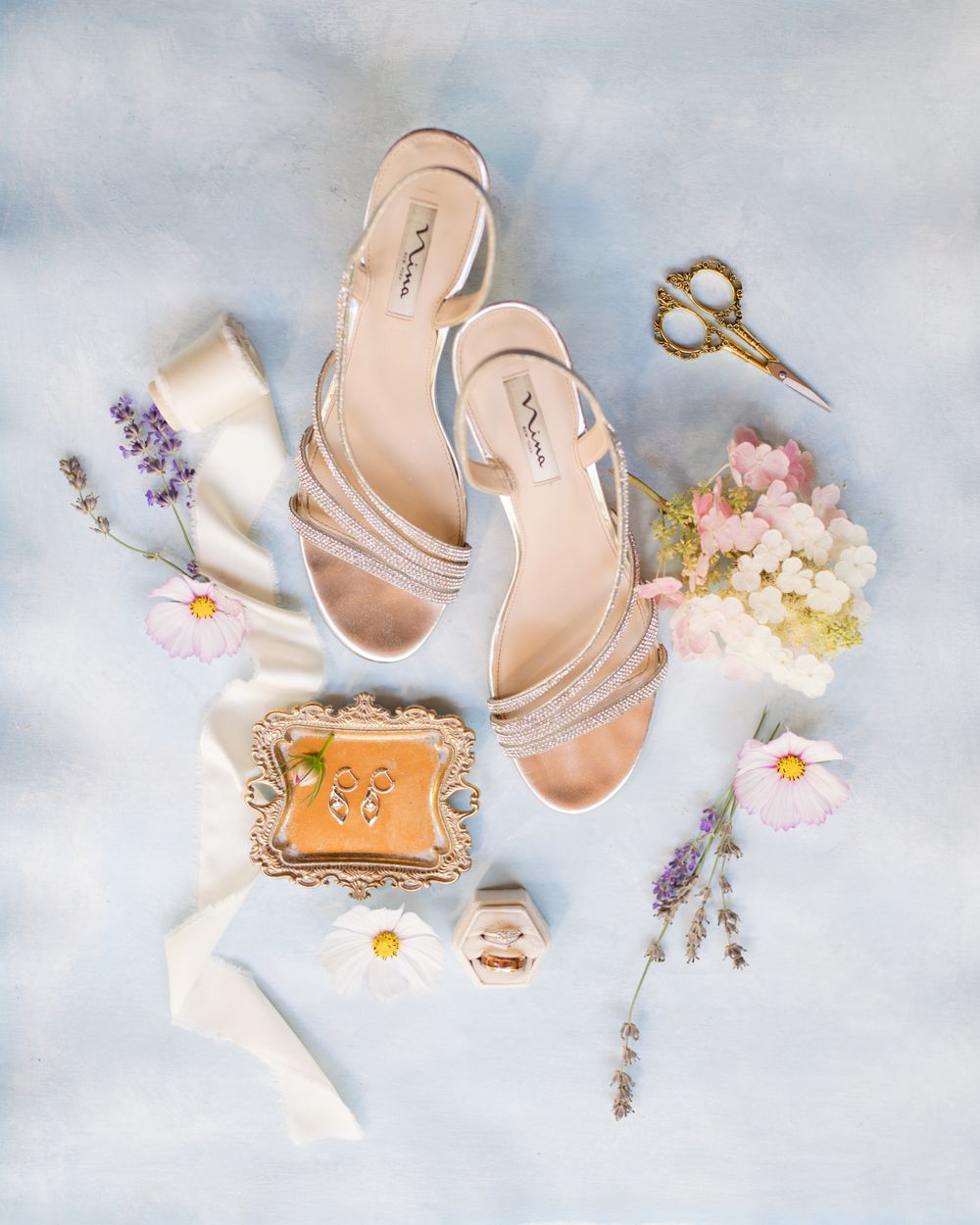 Flat lay photo of wedding shoes and jewelry