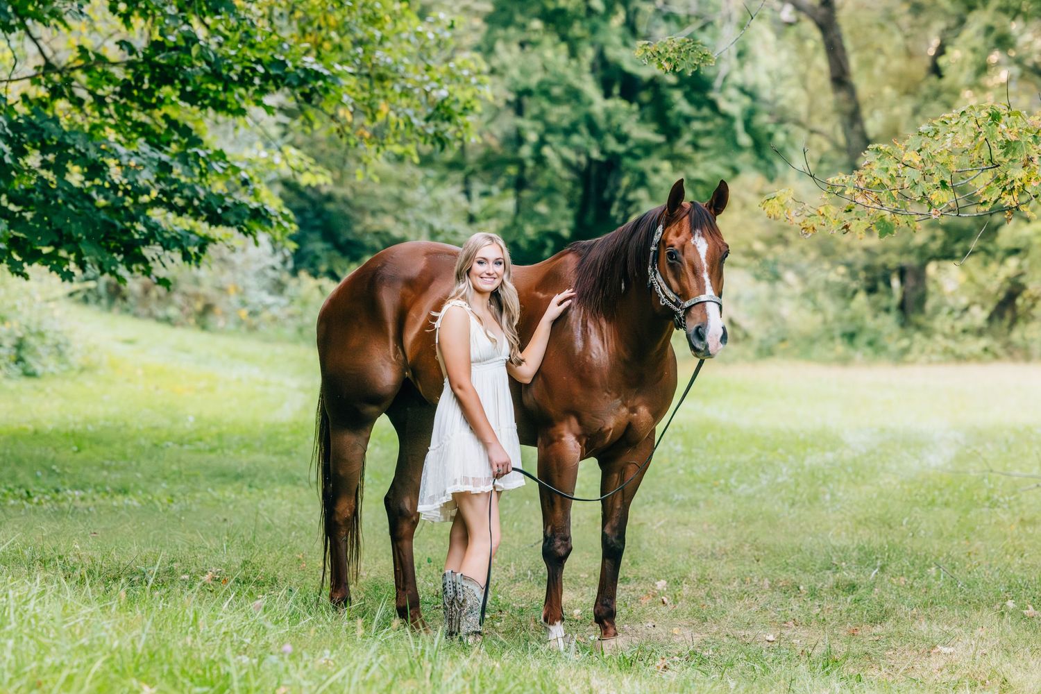 Senior posed with horse in field