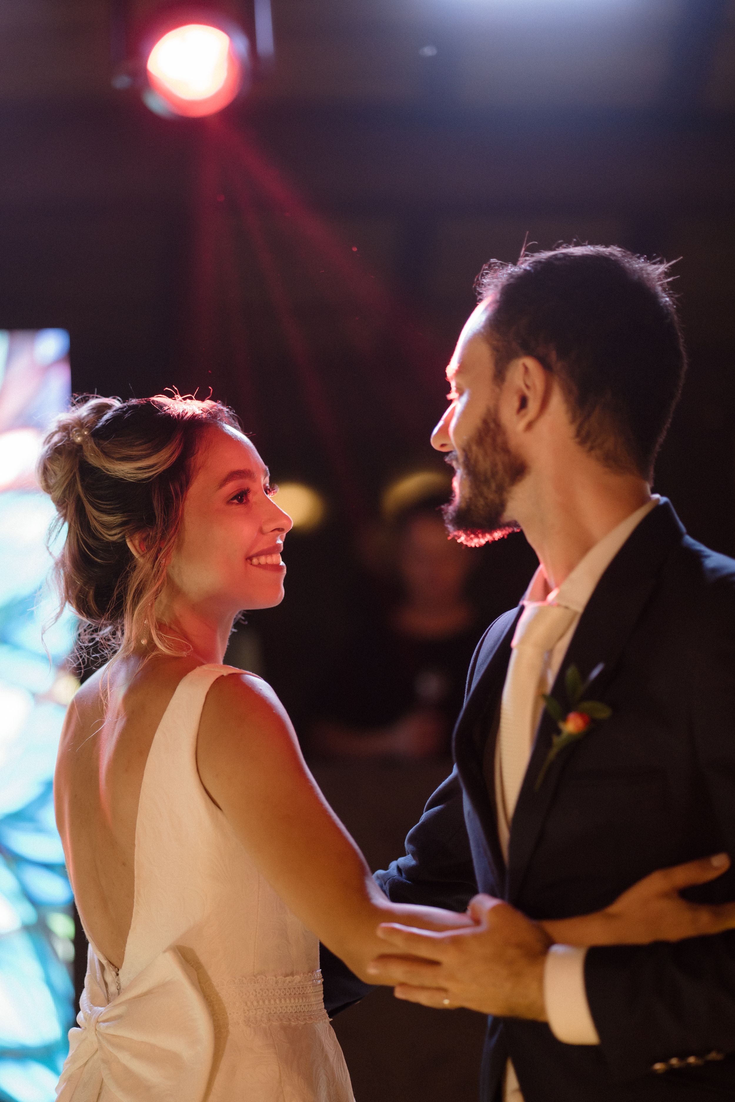 A joyful dance moment captured under warm lighting at a reception.