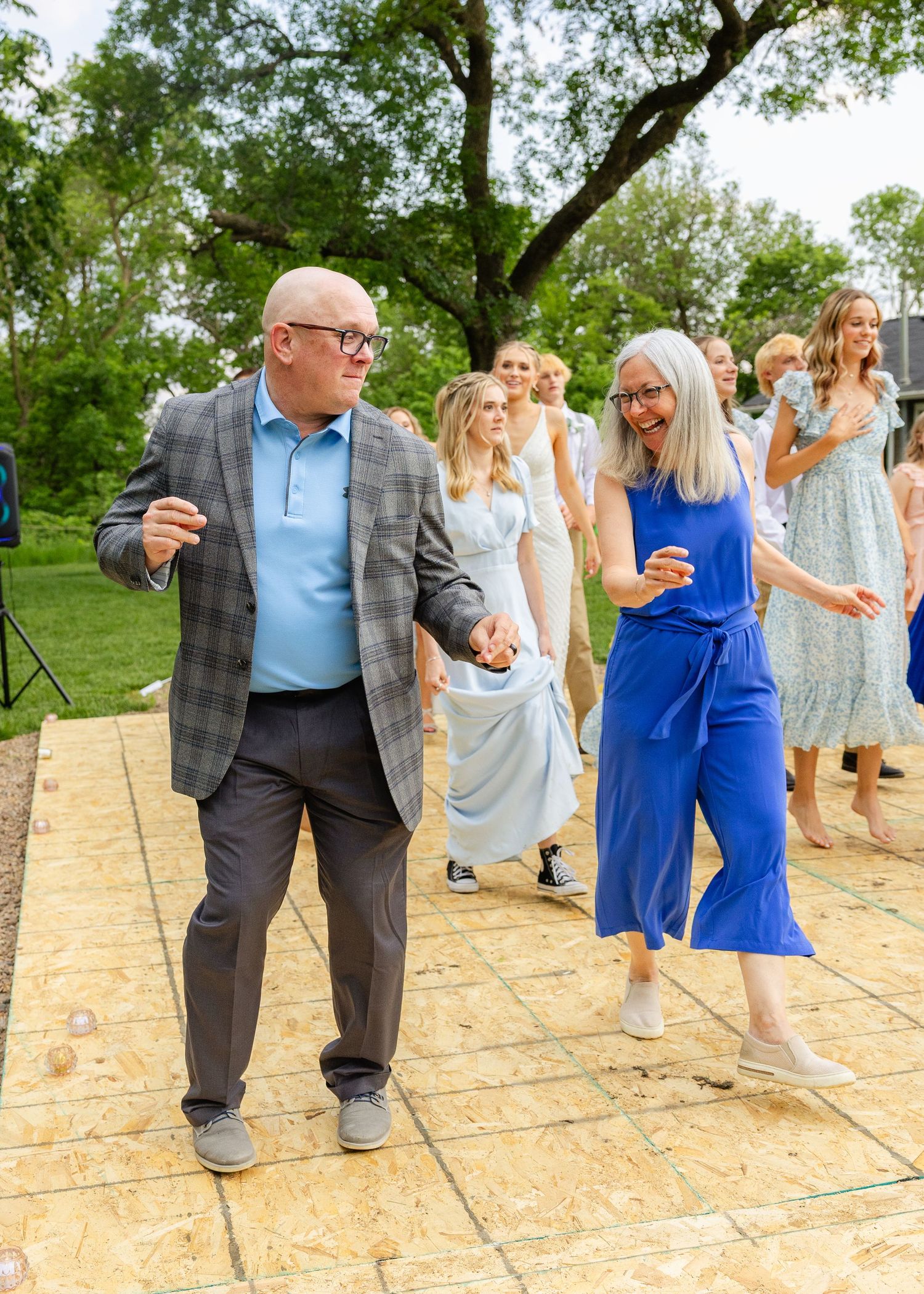 couple dancing at a wedding reception outside in nature