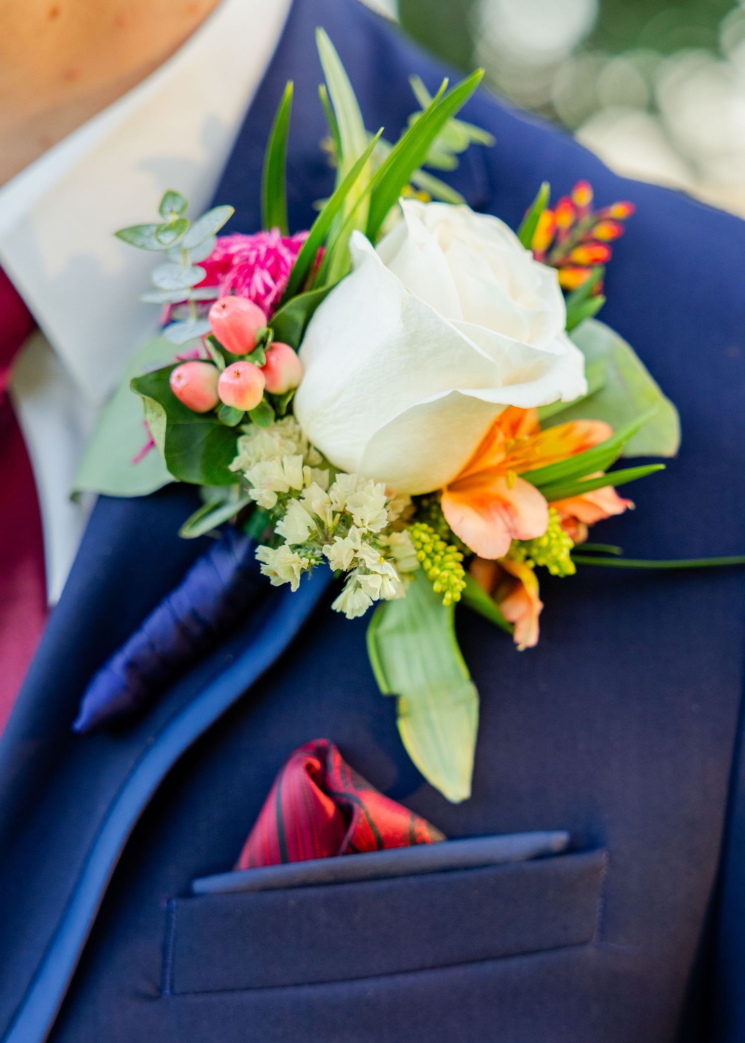 detail photo of boutonniere on a groom on a wedding day