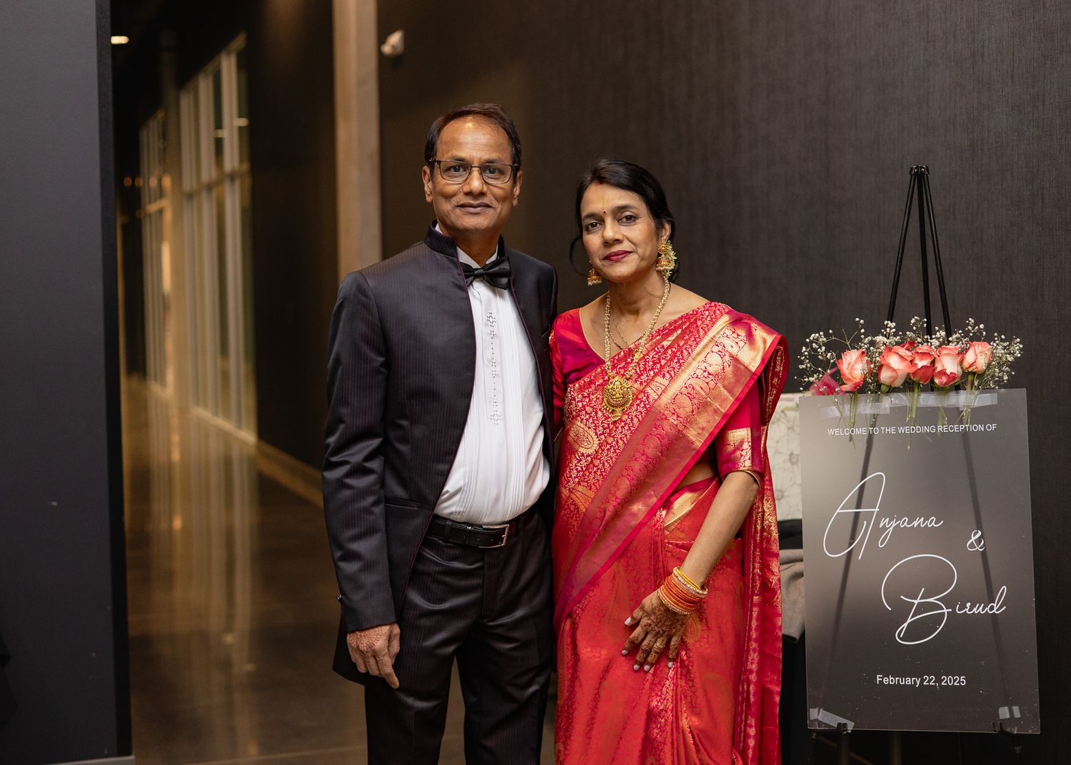 wedding photo of couple at their wedding reception  posing for a picture