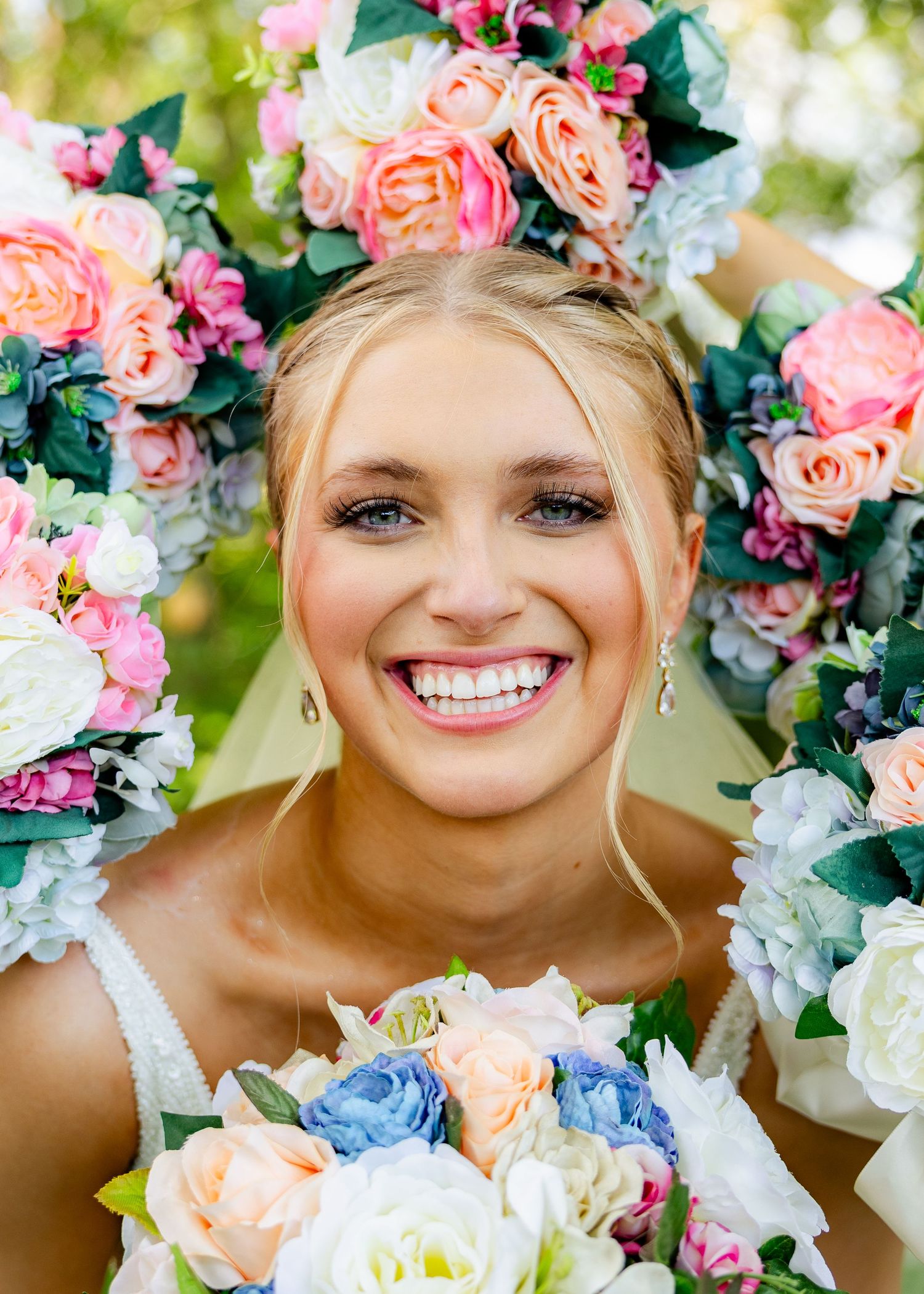 bride with flowers surrounding her on wedding day