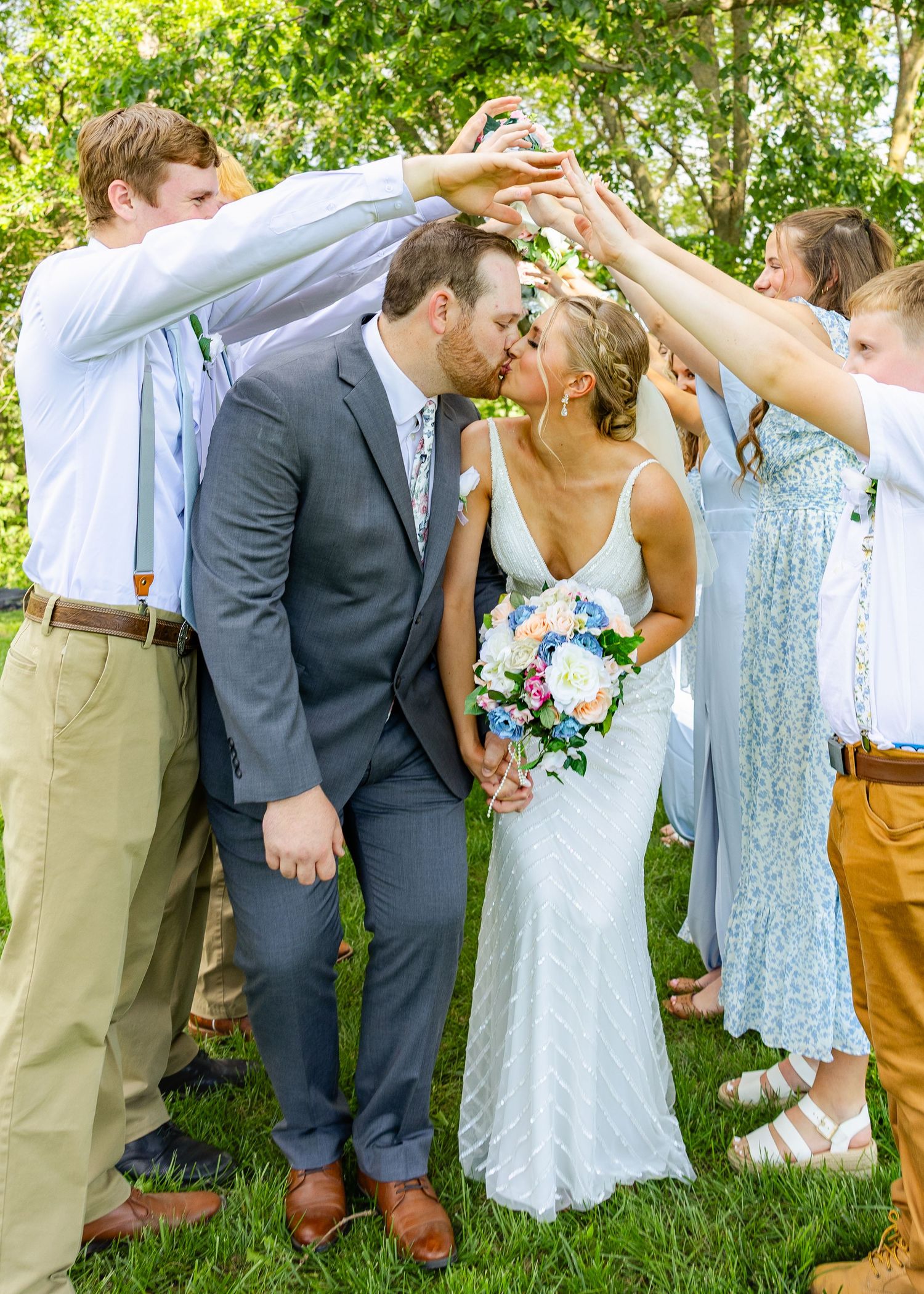 wedding photo of couple on their wedding day with wedding party