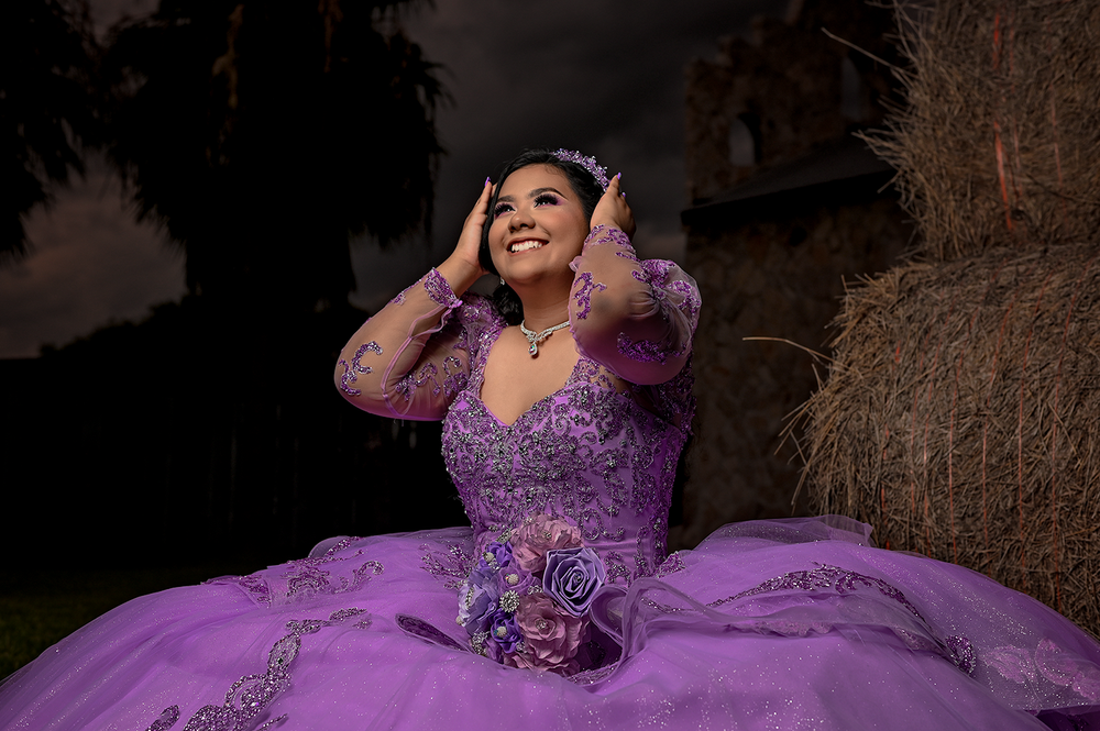 Beautiful purple ballgown dress photographed against a dusky outdoor setting.