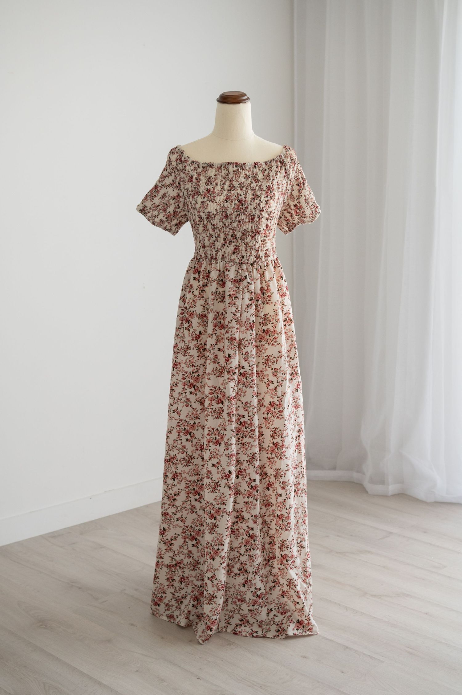 Floral print maxi dress with puff sleeves displayed on mannequin against white background.