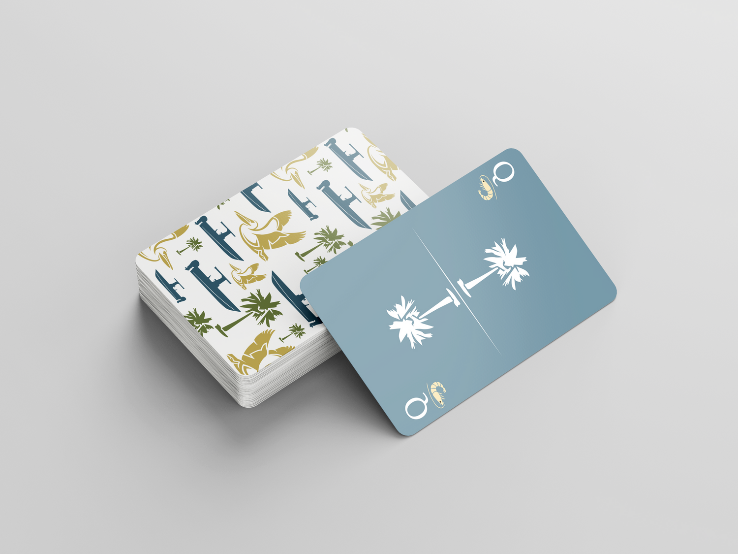 Playing card deck featuring palm tree designs in blue and gold with pattern detail.