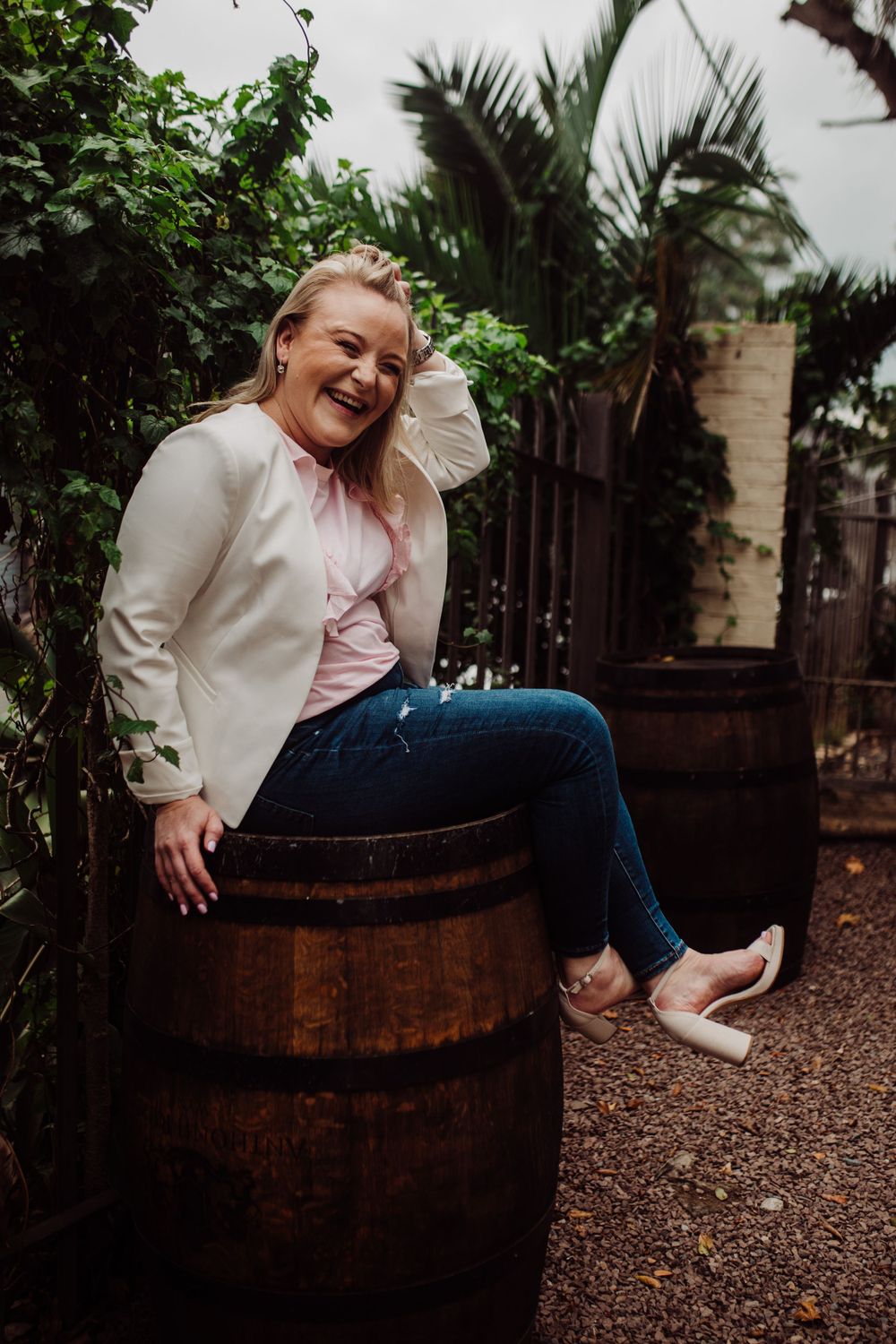 lady sitting on wine barrel