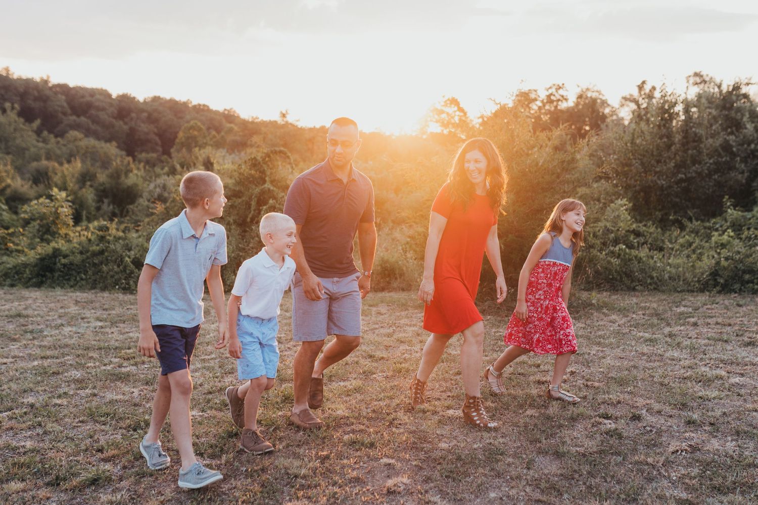 Family walking outdoors wearing orange, blue, and white