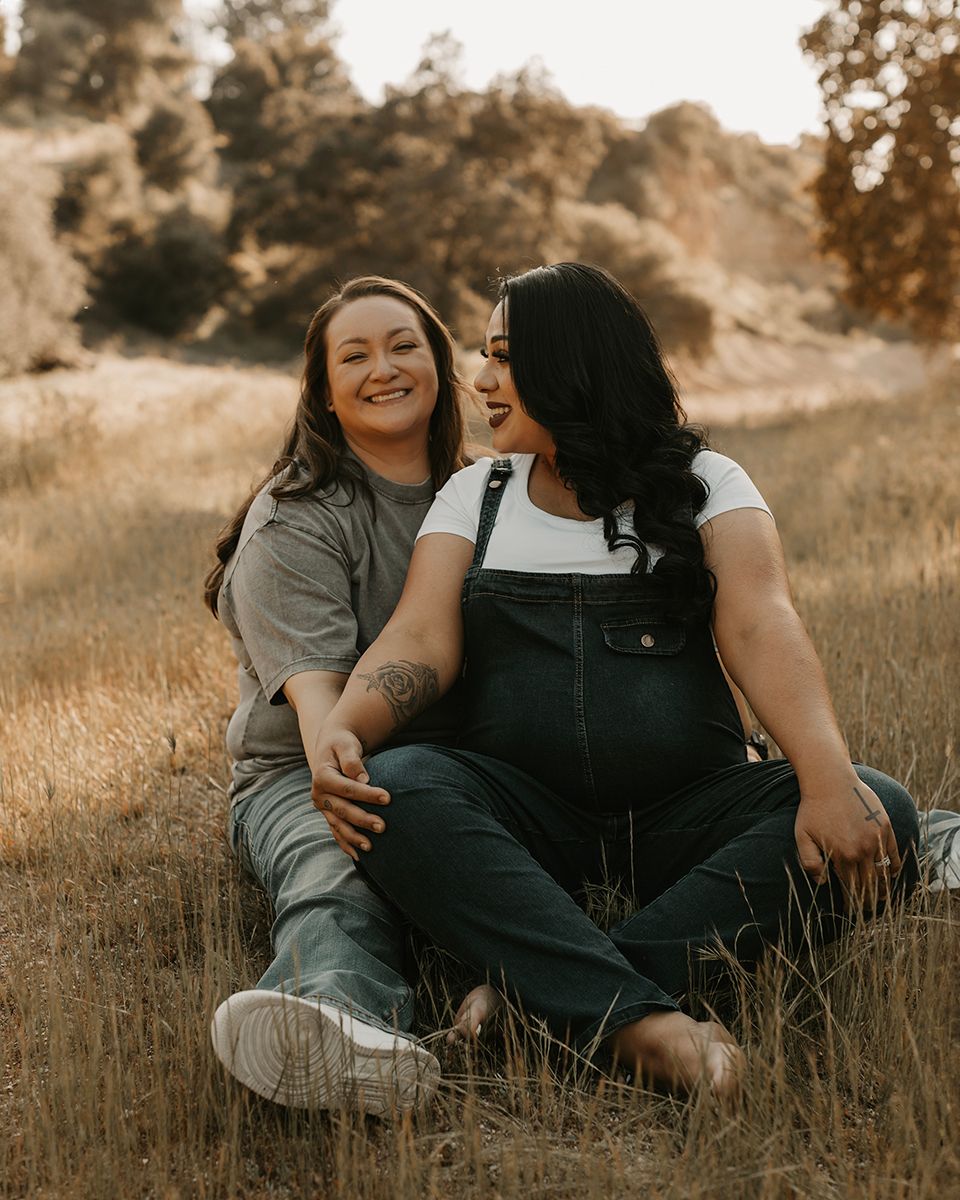 Casual outdoor photoshoot captures genuine laughter and connection in golden light.