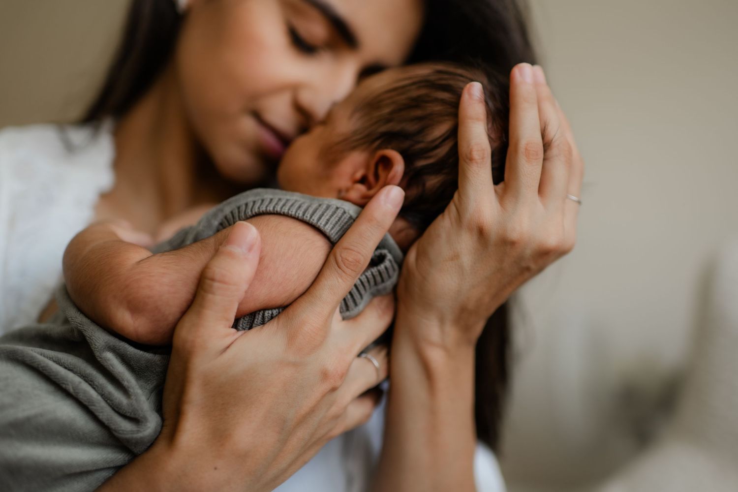 A close-up of a mother's hand  holding her new born baby during a new born session with Forever Ours photography in Kent