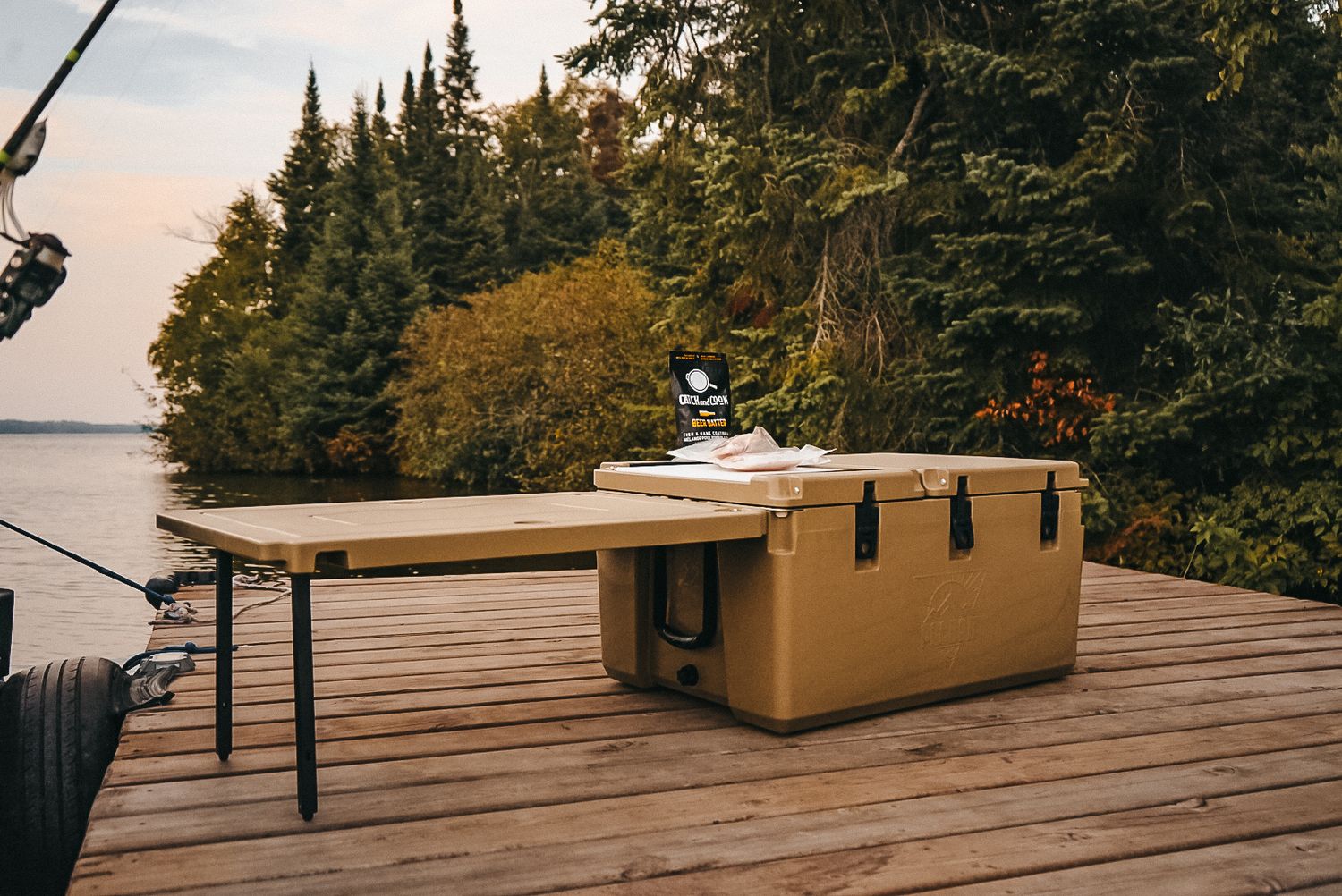 Multiple views of a tan cooler on wooden dock with scenic lake and forest backdrop.