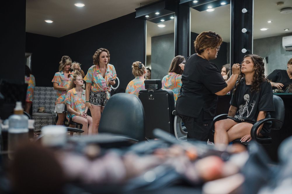 Behind the scenes preparation moment in a dressing room with vanity lights and mirrors, Sandos Caracol Wedding.