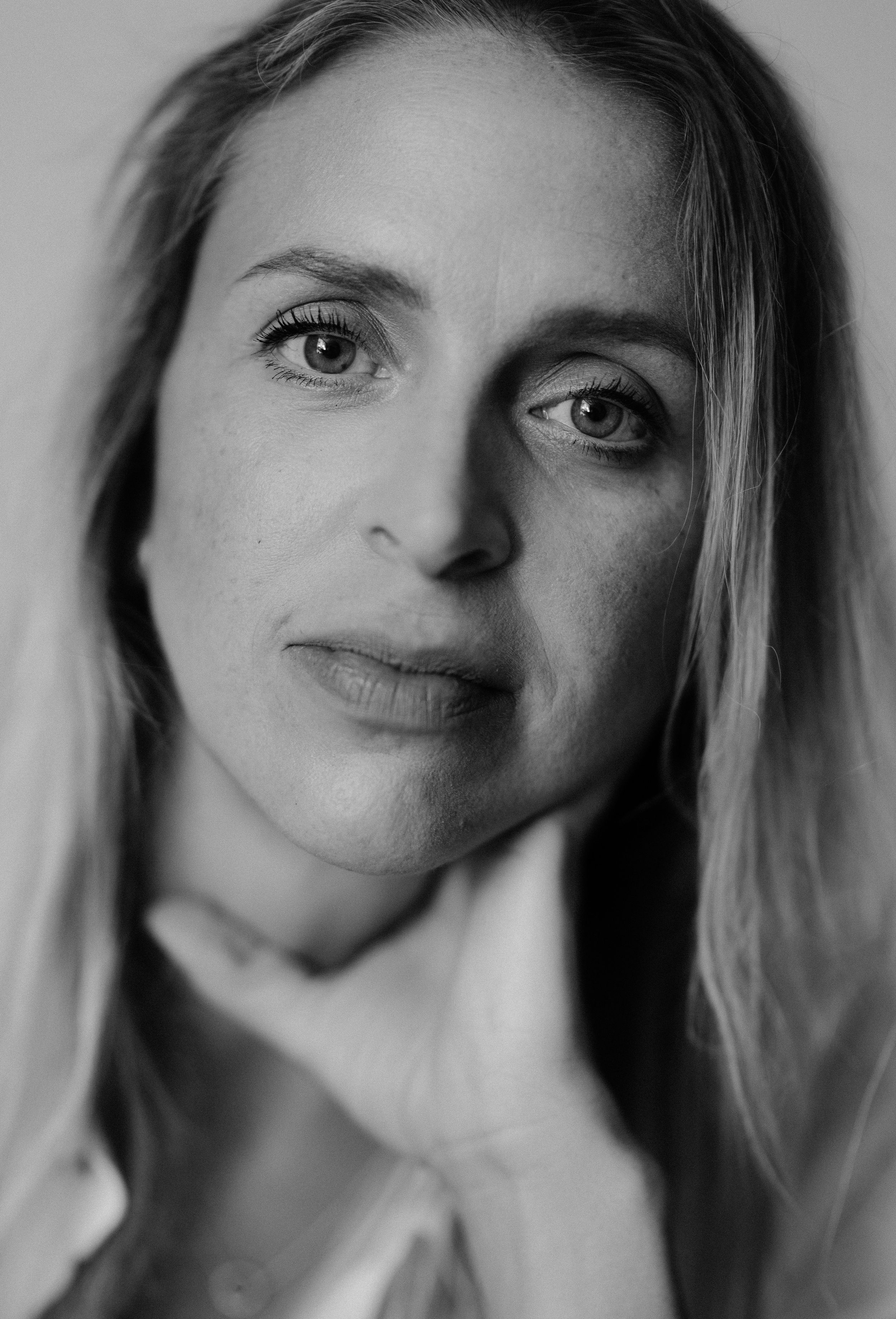 A dramatic black and white close-up portrait with natural lighting.