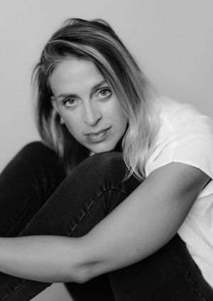 Intimate black and white portrait with soft lighting and natural expression.