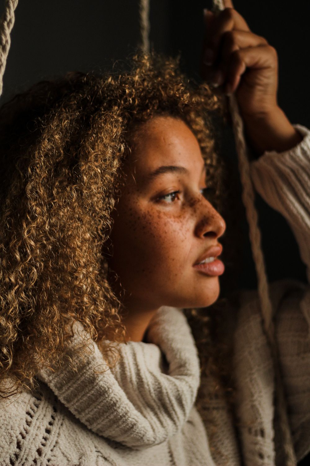 Portrait photography from a creative photoshoot of a model's side profile; moody and dramatic.