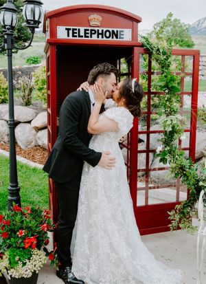 Romantic wedding photos taken in and around a classic red British telephone booth.