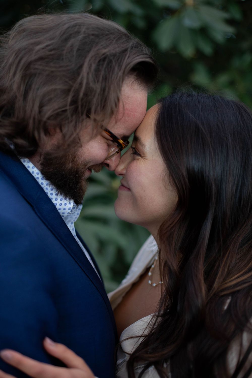 Intimate wedding moment captured in natural outdoor setting.