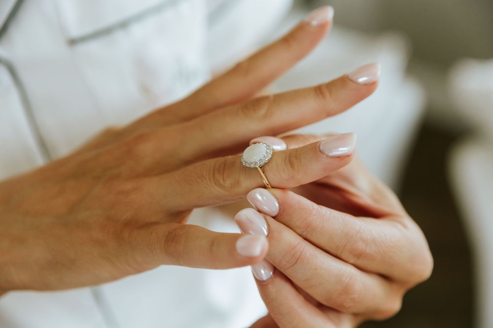 Close up shots of engagement ring and hands during wedding day preparations.