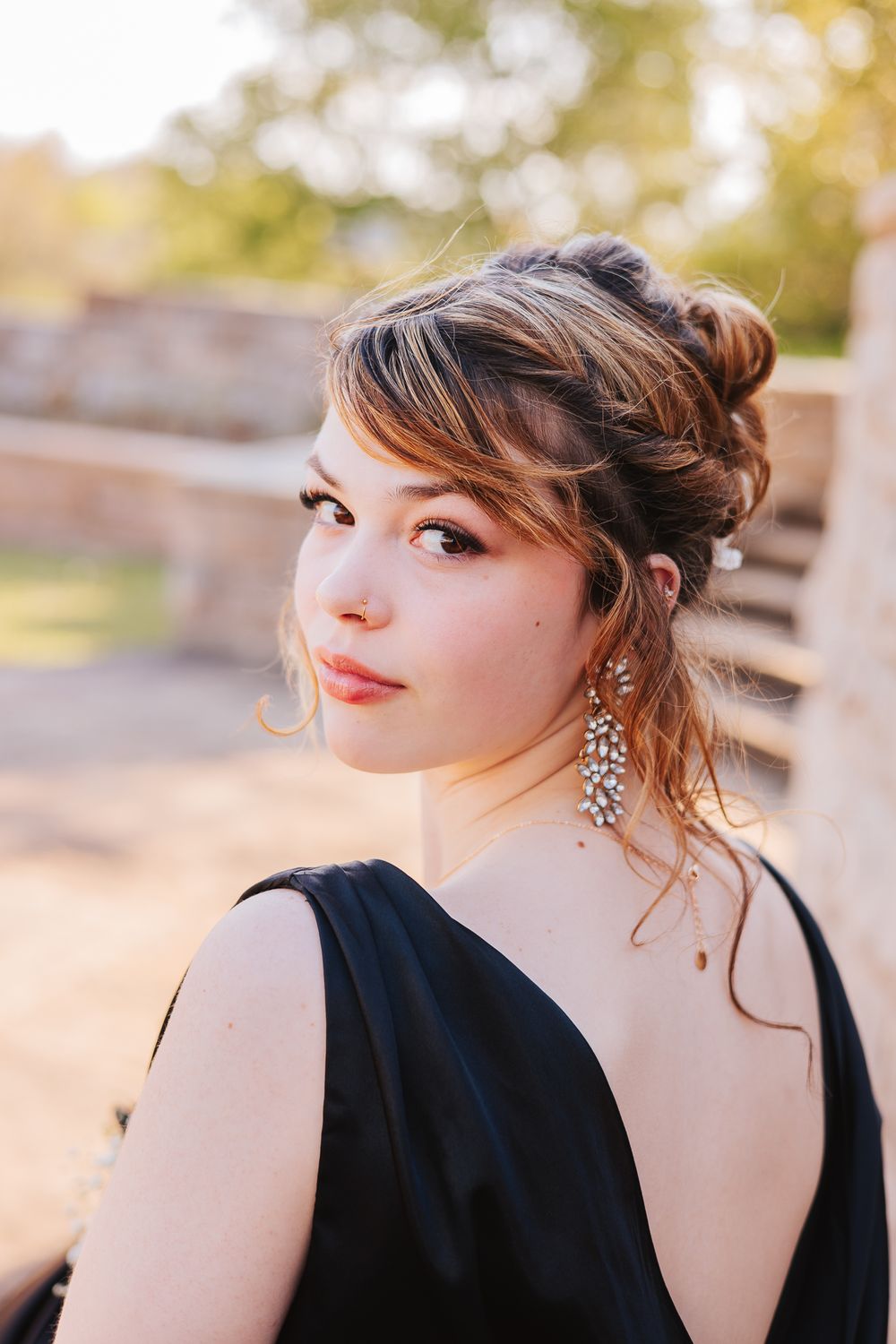 Artistic portrait series showing elegant formal styling with sparkly jewelry against a sunset backdrop.