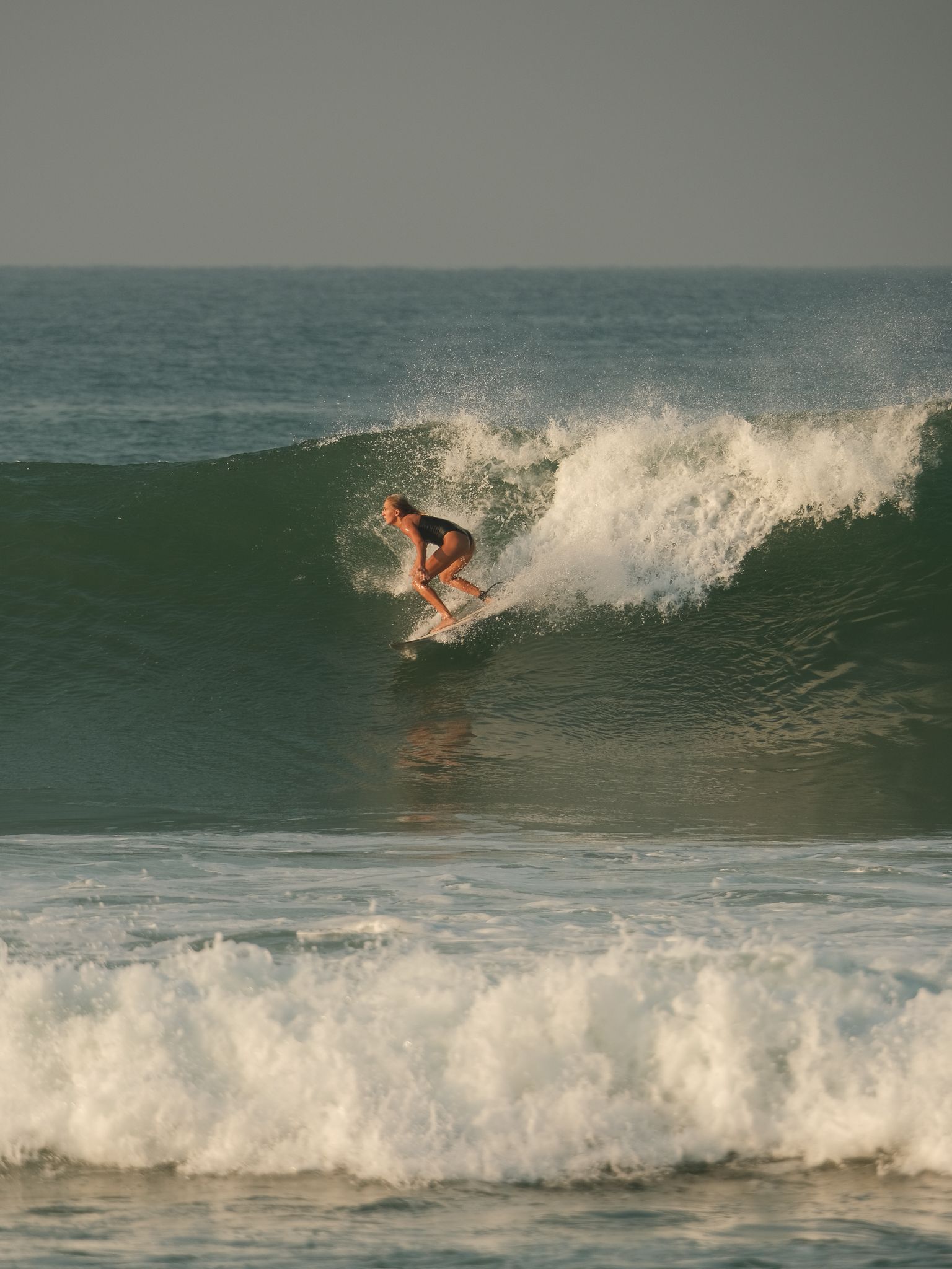 girl surfing big wave