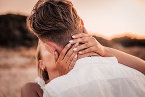 Romantic close-up of a couple embracing during sunset engagement photos in Mallorca.