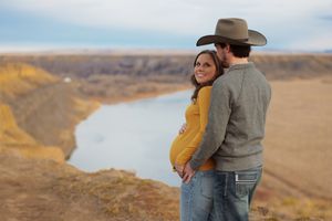 Maternity photoshoot with couple in western attire outdoors Chouteau County Montana Fort Benton Great Falls details unique photography River
