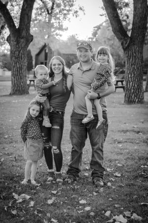 A black and white family portrait outdoors in park during autumn Fort Benton Chouteau County Montana family photoshoot fun photography