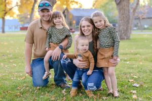 Loving family group poses together outdoors in autumn family photoshoot Fort Benton Montana Chouteau County Great Falls photography