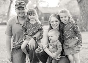 A happy family of five posing together outdoors for a black and white portrait family photography Fort Benton Chouteau County Great Falls