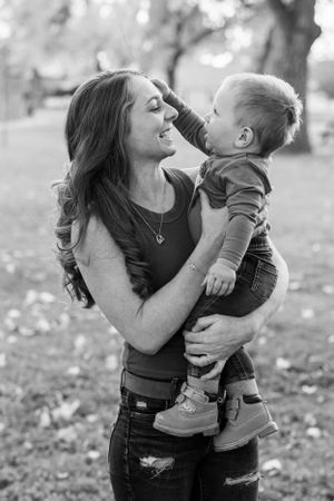 Candid photo of mom and son sharing tender moment outdoors in autumn Fort Benton Chouteau County Great Falls photography Montana