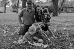 Black and white family portrait outdoors in park during autumn Fort Benton Chouteau County Montana family photoshoot fun photography