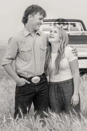 Brother and sister share a grin in wheat field in Chouteau County photography
