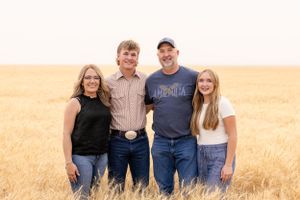 Senior photoshoot turns to family fun in golden wheat field on a summer day in Chouteau County photography