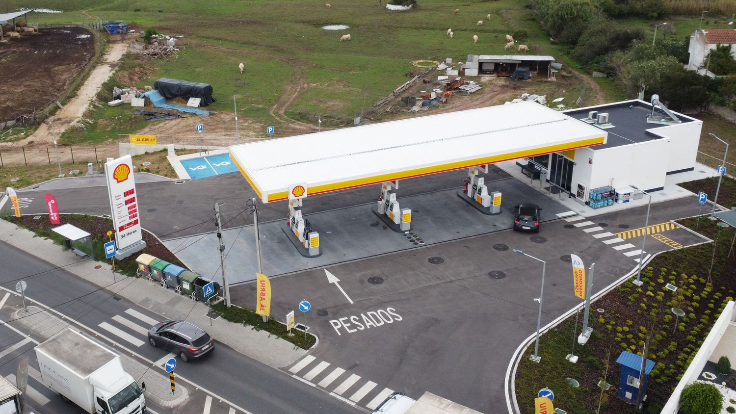 Aerial view of a Shell petrol station with multiple fuel pumps and heavy vehicle parking area.