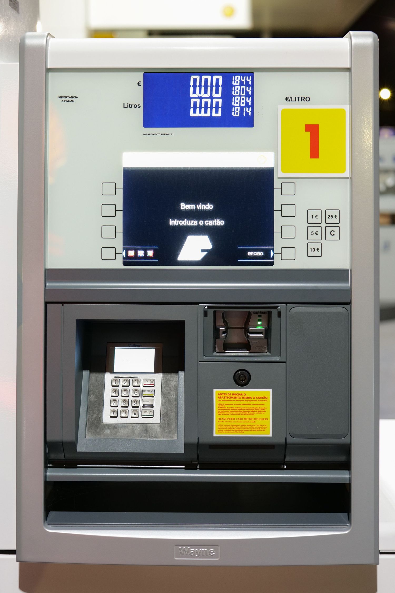 Shell gas station self-service fuel pump payment terminal with card reader and digital display.