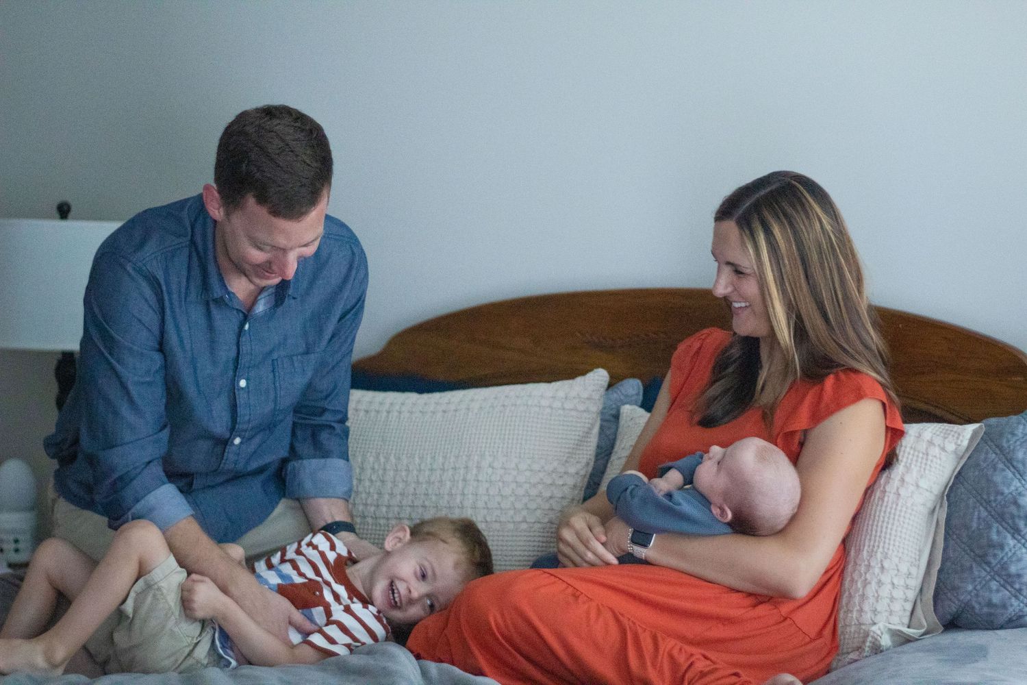 Family Lifestyle: Family playing on bed.