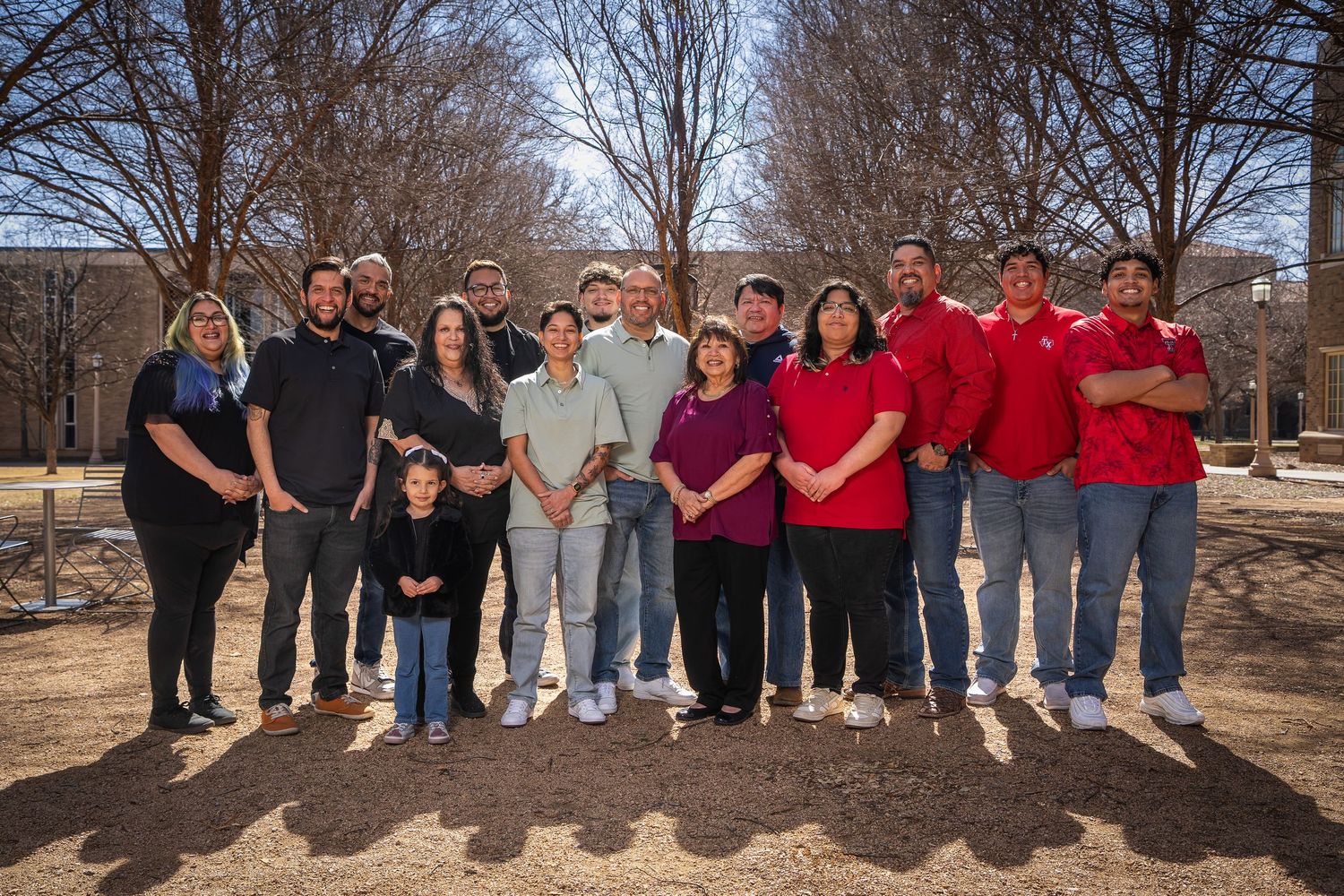 A group of people wearing casual attire stand together outdoors for a series of group photos in winter.