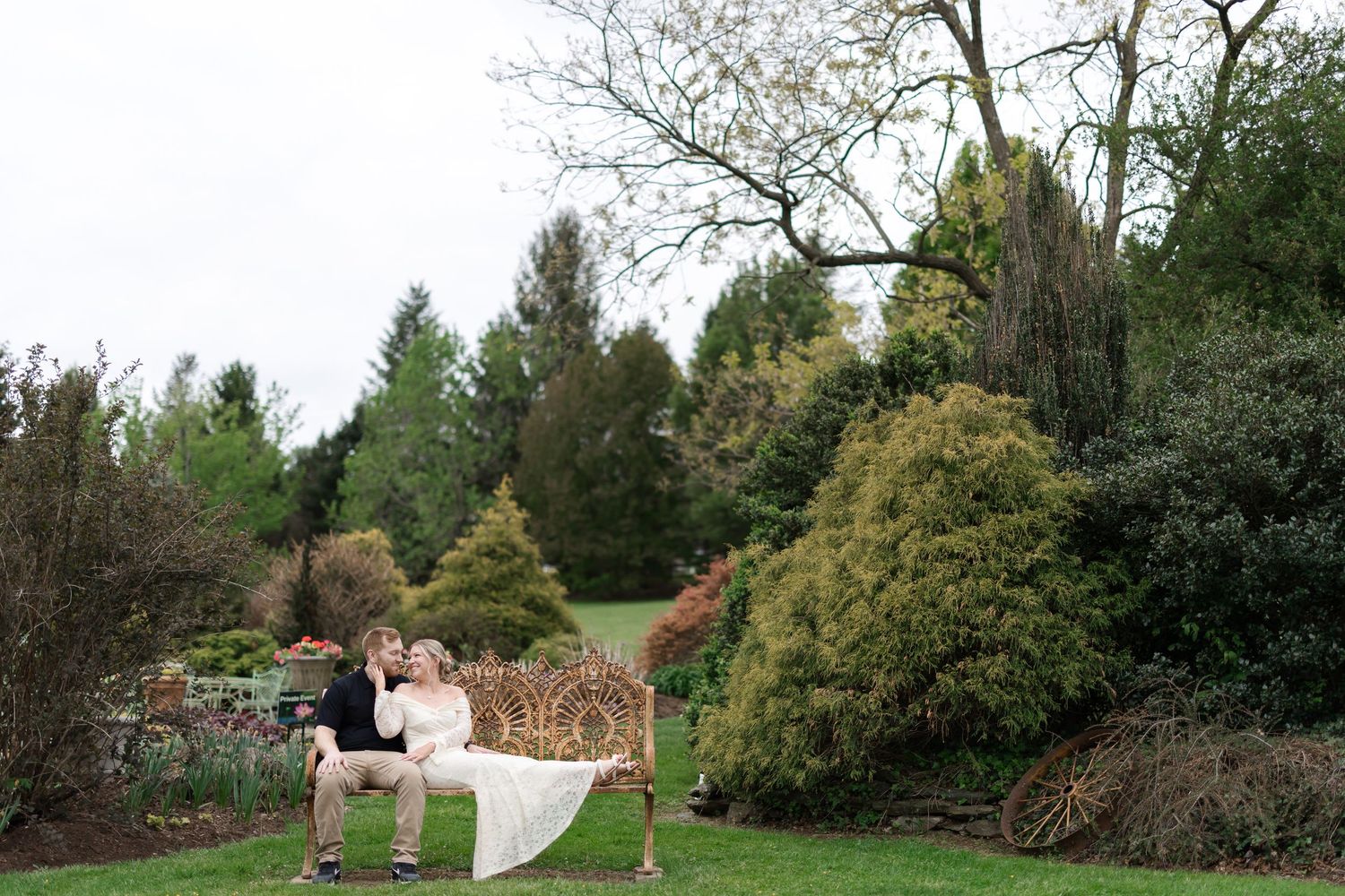 A couple dances together in an elegant white room with grand arched windows and sunlight streaming across the floor.