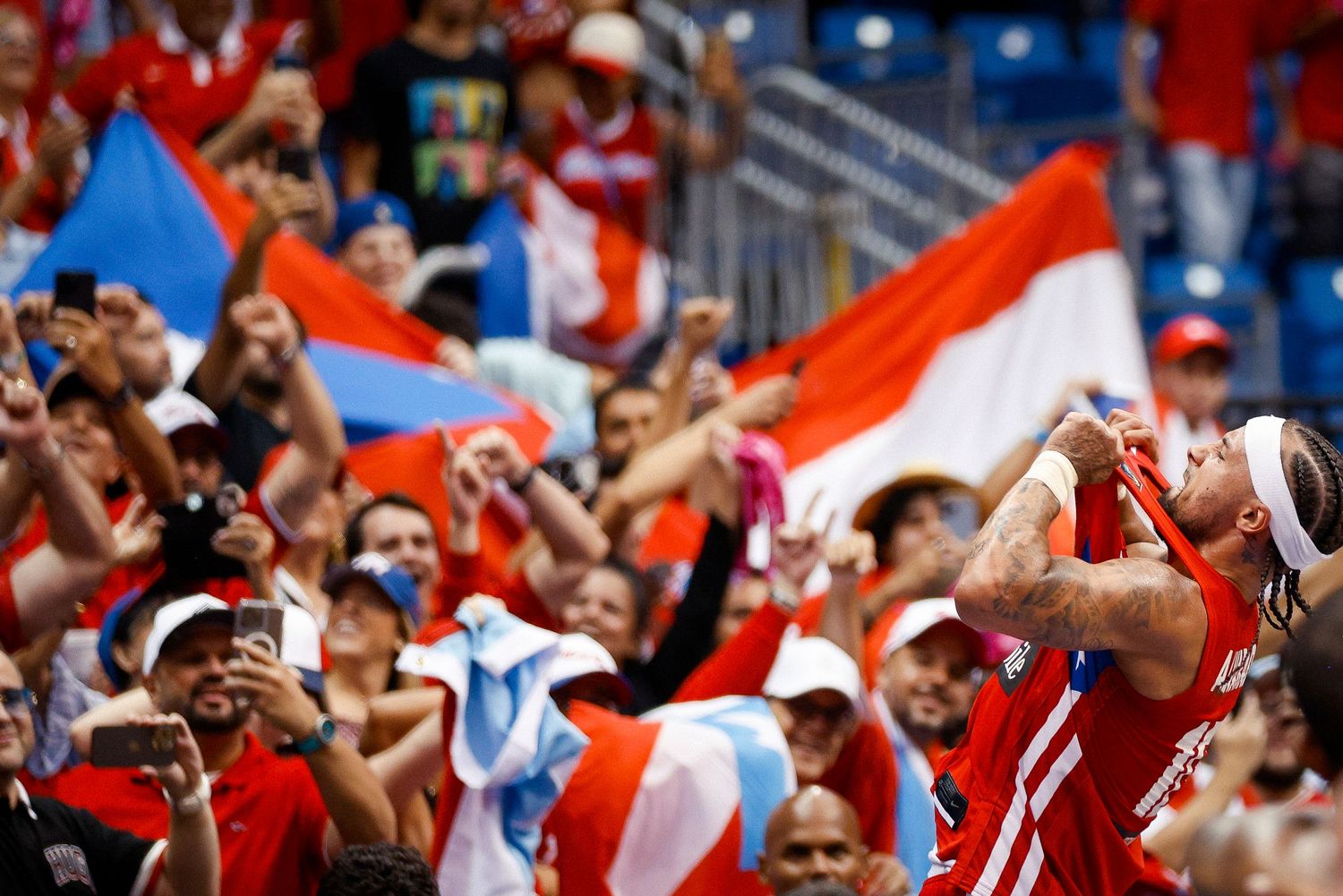 José Alvarado of Puerto Rico celebrates with the fans after qualifying for the Olympic Games in Paris 2024.