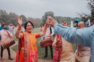 Celebratory dancing with drums during an outdoor Indian cultural festival.