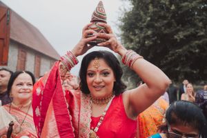 Someone balances a decorative pot on their head during a traditional Indian celebration.